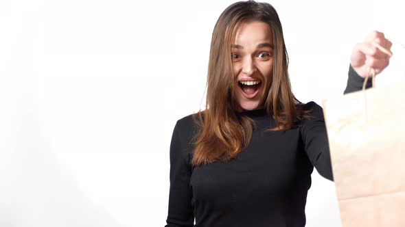 Happy woman with shopping bags. Young woman with shopping on white background