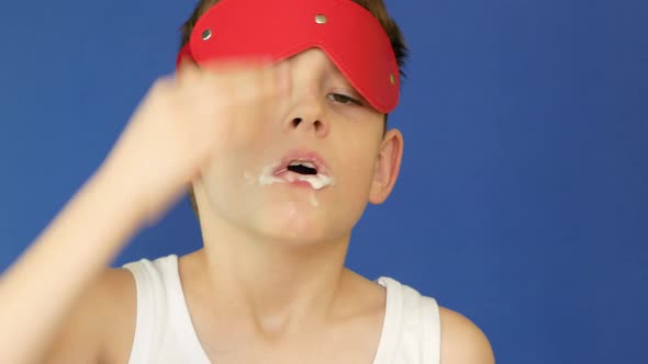 Sleepy caucasian boy 7 years old brushes his teeth in the morning