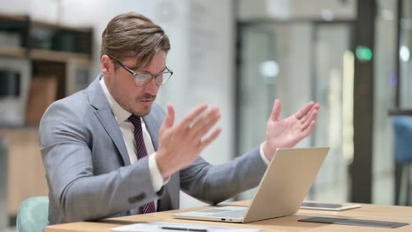 Loss, Businessman Reacting To Failure on Laptop in Office 