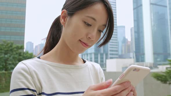 Woman use of cellphone at central of Hong Kong