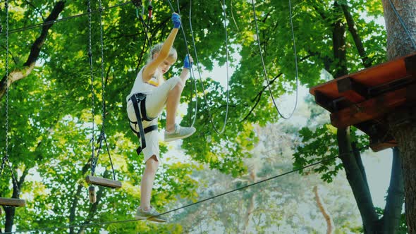 Girl Overcomes Fear Walks on a Rope High Above the Ground