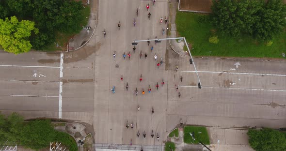 4k Birds eye view of bicyclists riding through streets