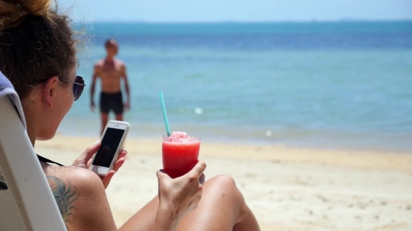 Summer Girl With Smartphone On Beach Sun Lounger 