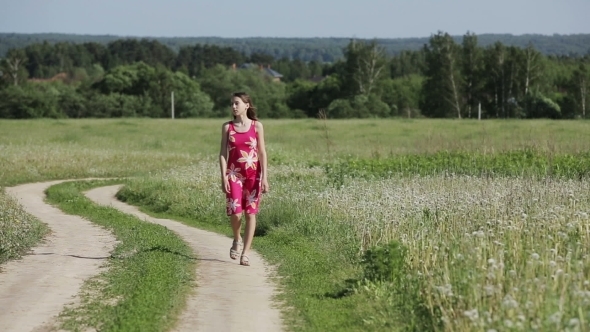 Girl Walking By Road In Field alt