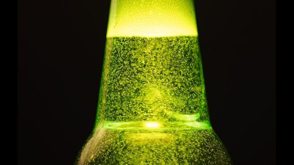 A Green Bottle Neck With A Lot Of Bubbles