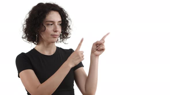 Video of Young Attractive Woman with Short Curly Hairstyle Wearing Casual Tshirt Pointing Fingers at