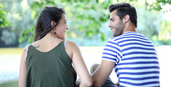 Young Couple Flirting On The River