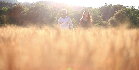 Couple In Love Walking On A Field