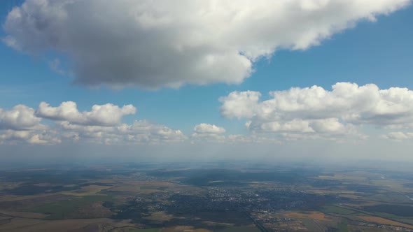 Aerial View at High Altitude of Earth Covered with White Puffy Cumulus Clouds