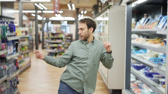 Man in Supermarket Positive Dances in an Empty Food Store