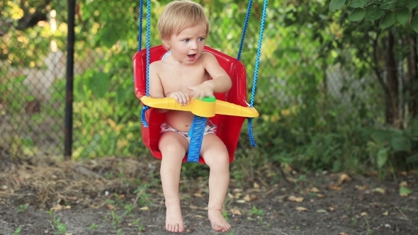 Child On Swing In Garden alt