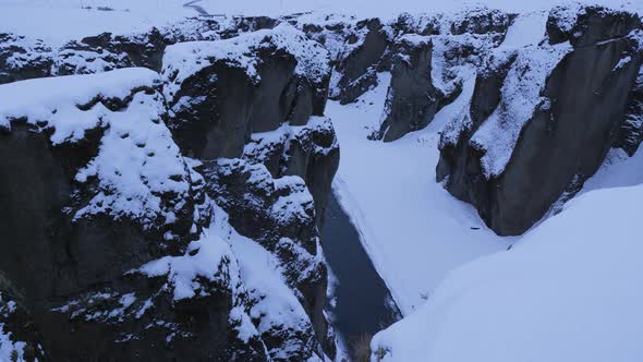 Iceland Winter View Of Large Snow Covered Valley With Rushing Water Below 4