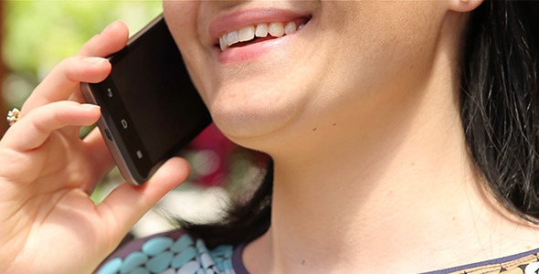 Smiling Woman Talking on the Smartphone Closeup