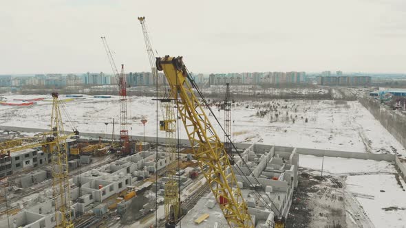 Close Yellow Construction Crane Against Cottage District