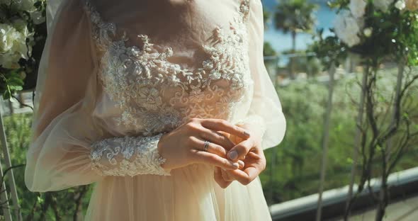 Female hands hold engagement wedding rings.