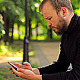 The Young Man With the Phone Sitting in the Park - VideoHive Item for Sale
