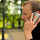 The Young Man With the Phone Sitting in the Park - VideoHive Item for Sale