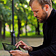 Man With the Tablet Computer on a Bench in a Park - VideoHive Item for Sale