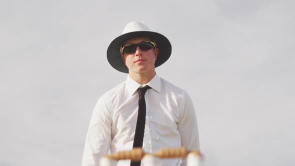 Cricket umpire making signs standing on a cricket pitch