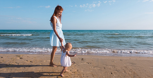 Mother and Child Walking Along the Seashore