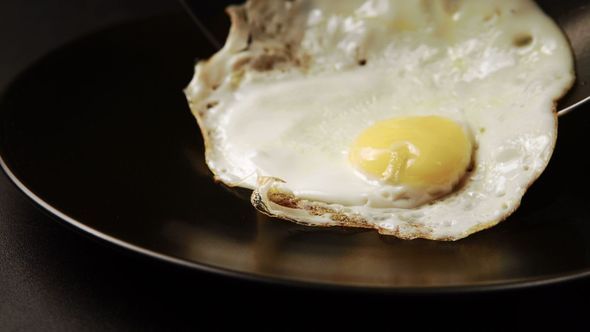 Taking Out Of A Fried Eggs From The Pan