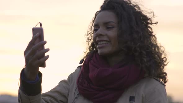 Young Beautiful Woman Watching Favorite Music Clip on Smartphone, Dancing