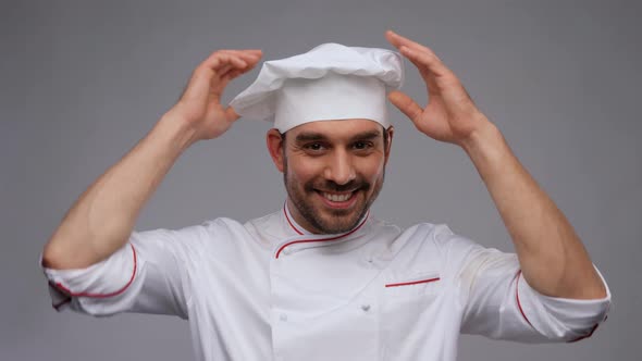 Happy Smiling Male Chef Adjusting Toque