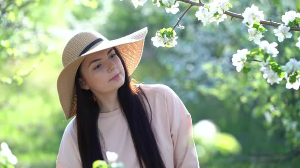 Beauty Young Woman Enjoying Apple Blooming Spring Orchard.