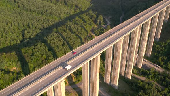 Aerial Top View of Summer Traffic Driving on a Highway Viaduct at Sunset