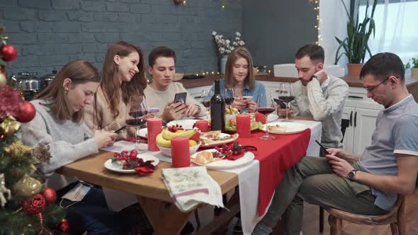 Group of Bored Upset Young Friends Using Mobile Phones Struggling of Boredom Sitting Together