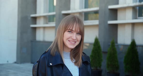 Portrait an Attractive Young Woman Cute Cheerful Girl Smiling Looking at Camera Over City Building