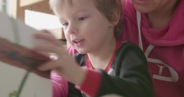 Close up of kid being read to another angle