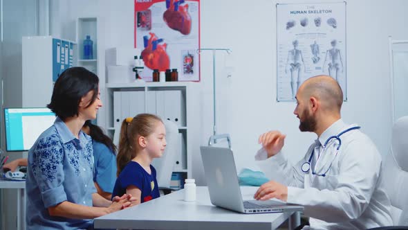 Doctor and Patients Looking at Radiography