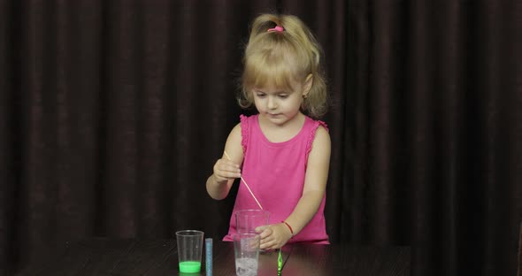 Child Having Fun Making Green Slime. Mixes Ingredients. Kid with Hand Made Toy