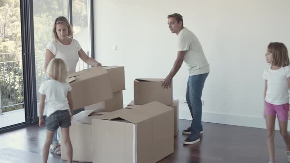 Happy Parents and Two Girls Moving Into New Flat