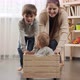 Baby boy sitting in wooden toy box while his family riding him - VideoHive Item for Sale