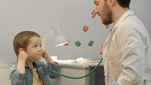 Young Boy Listening To Doctor's Heart With
