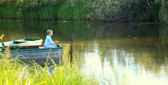 Little Boy Fishing from Boat on River