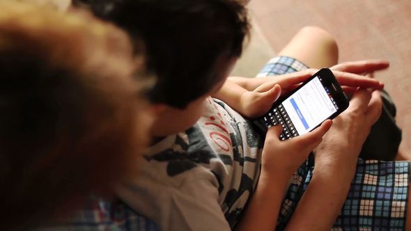 Child Is Typing A Text On A Smartphone