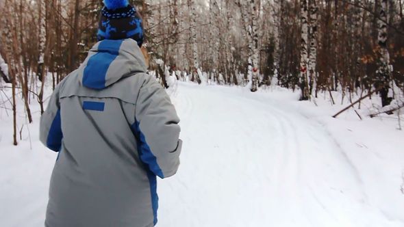 Adult Woman Is Running In The Winter Park