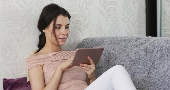 Happy Young Woman Holding Digital Tablet Involved in Pleasant Web Camera Video Call Conversation