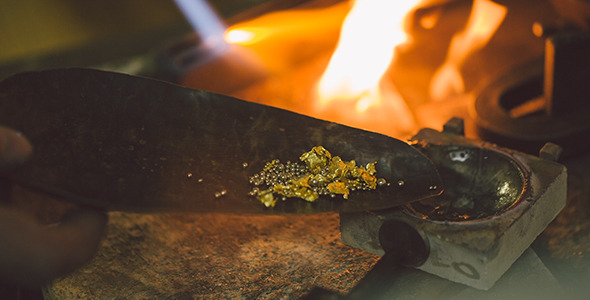 Pouring Gold And Metal In Stone Cup