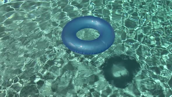 Inner Tube Floating In A Swimming Pool alt