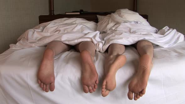 Feet Of Couple In Bed 3
