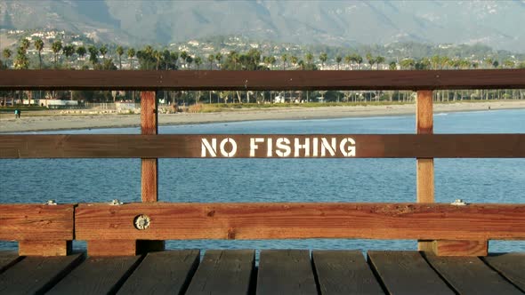 No Fishing Sign Painted On Pier