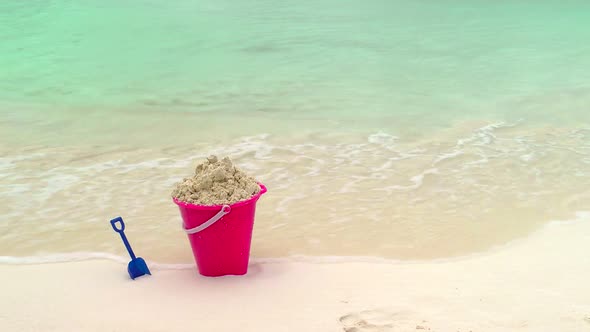 Childs Bucket And Shovel Sitting On Tropical Beach