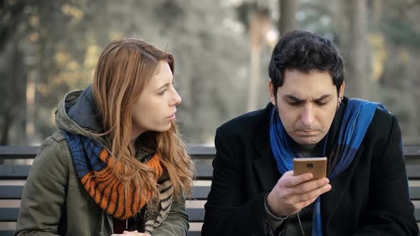 woman arguing with her boyfriend using cell phone and does not listen to her