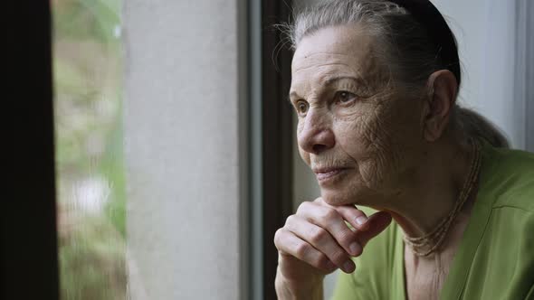 Grandmother Looks Outside the Window