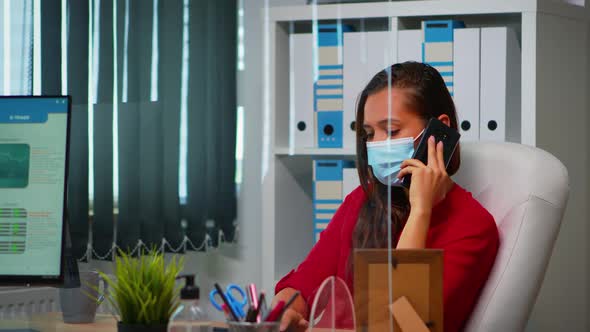 Woman Talking on Phone Wearing Mask