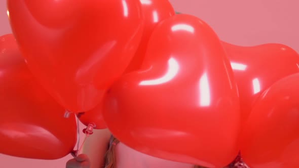 Beautiful Little Girl Appearing Behind Red Balloons, Valentines Day Surprise